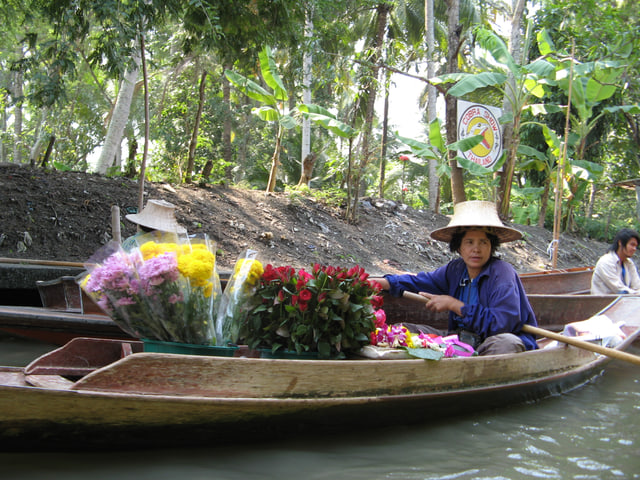 Archive photograph: A flower-filled wooden boat beside other boats at Pattaya Floating Market
